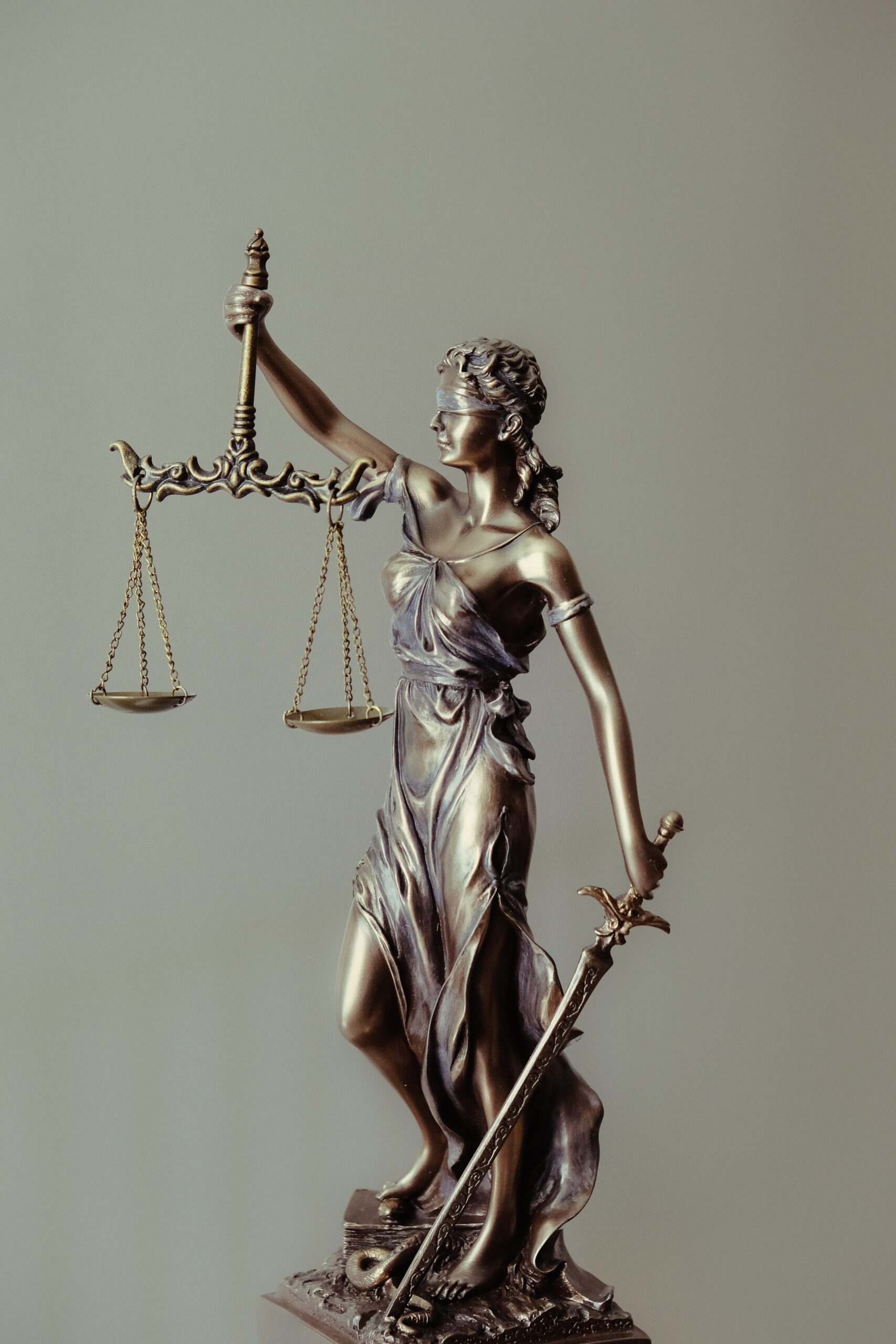 Blind-folded Gold Lady Justice Holding Sword in Left Hand and Scales of Justice in Right